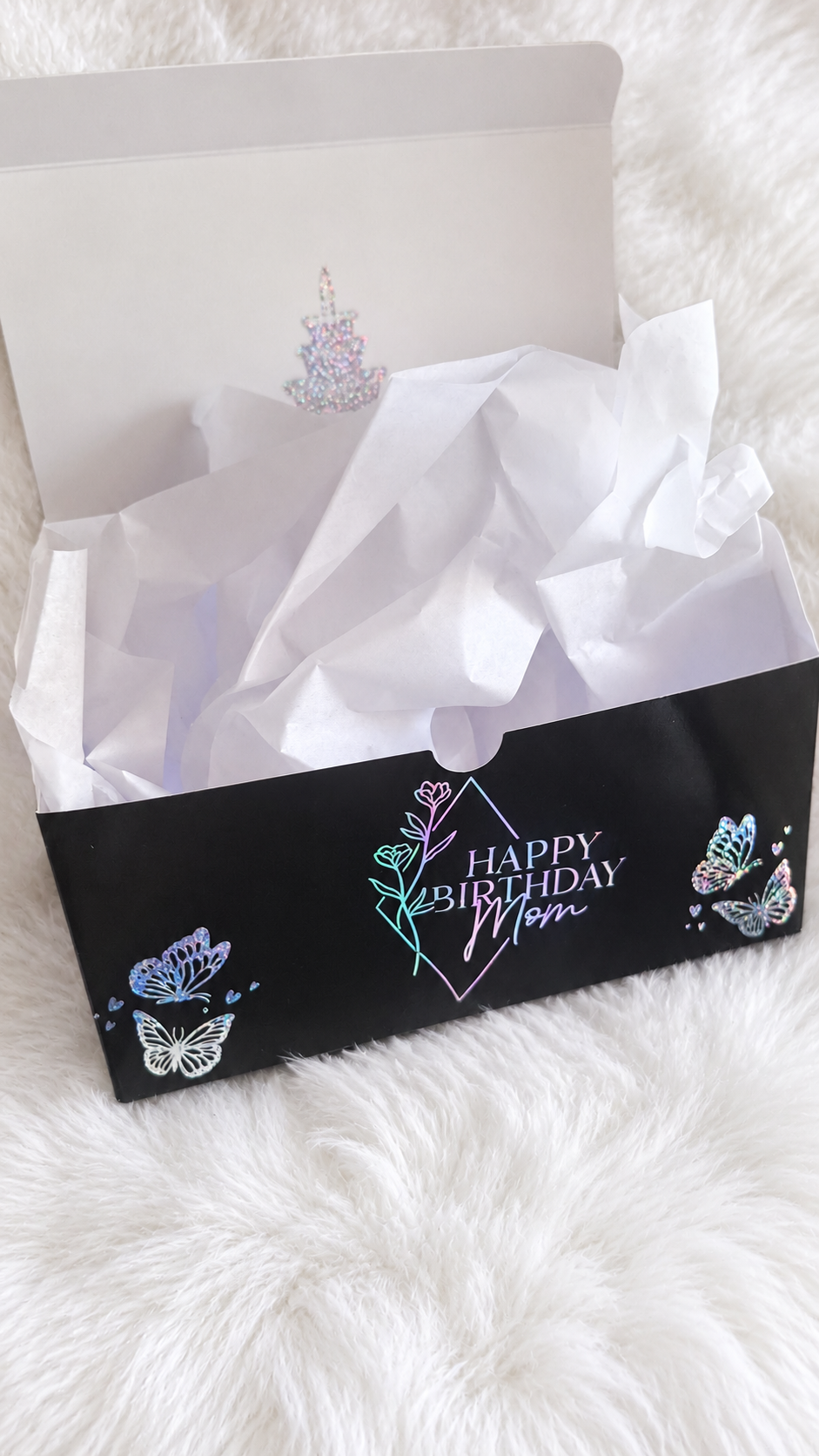 Personalized Happy Birthday Mom gift box on a white plush rug